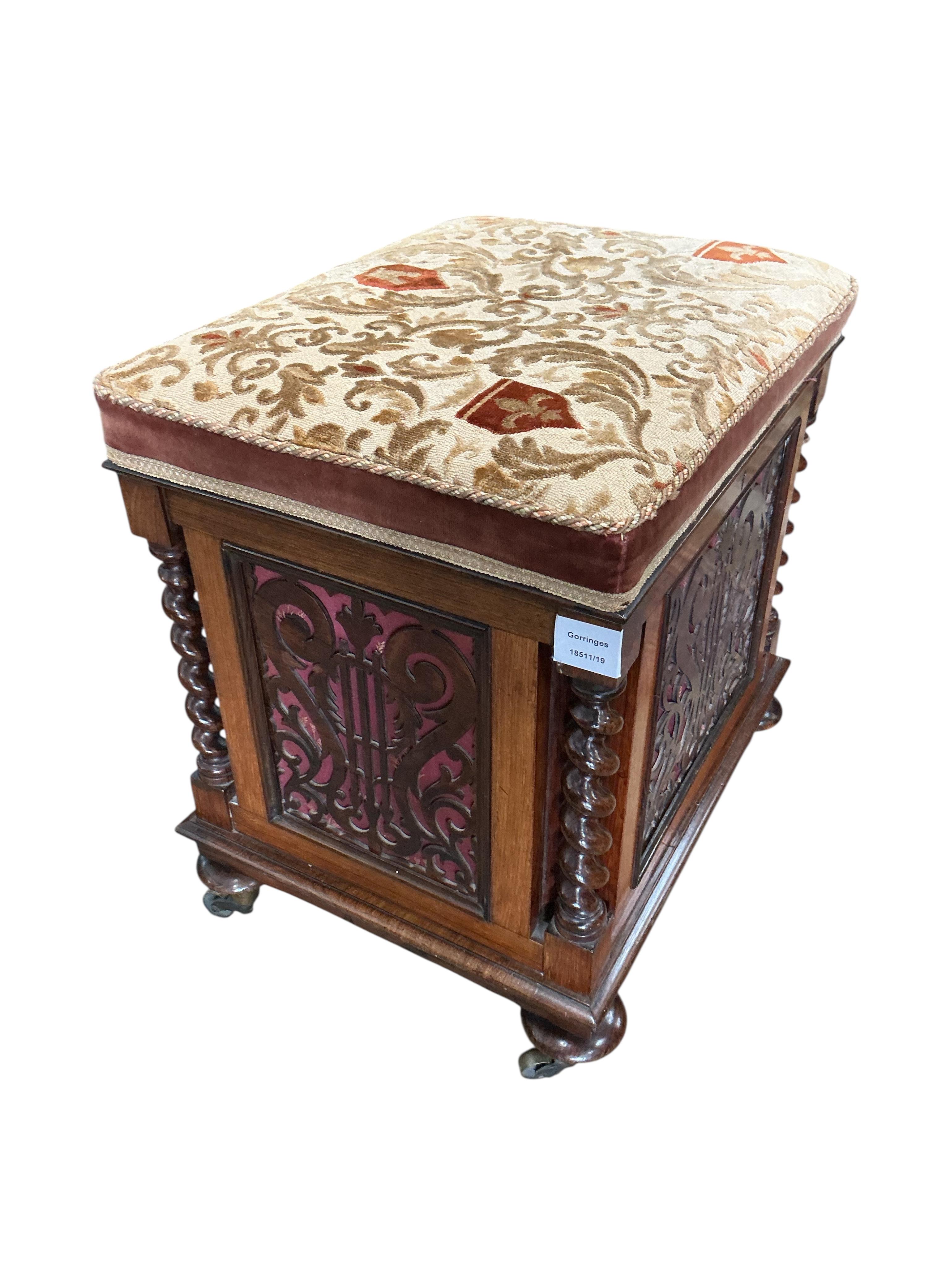 A Victorian rosewood upholstered box seat music stool with fret cut panels, width 47cm, depth 38cm, height 52cm